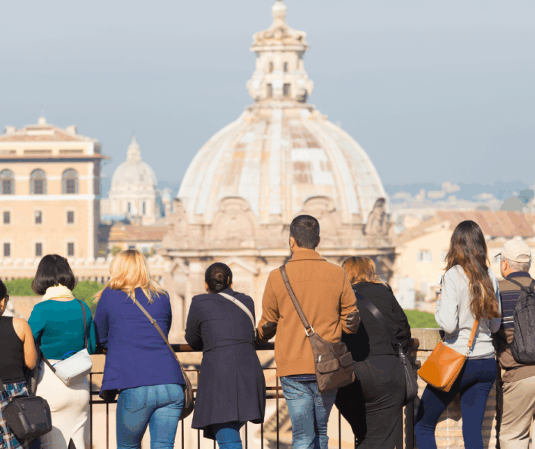 Travelers enjoying a guided tour in Rome, overlooking historic architecture—an example of small-group travel in Europe.