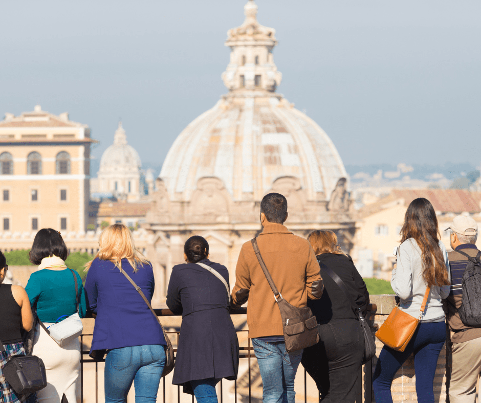 Travelers enjoying a guided tour in Rome, overlooking historic architecture—an example of small-group travel in Europe.