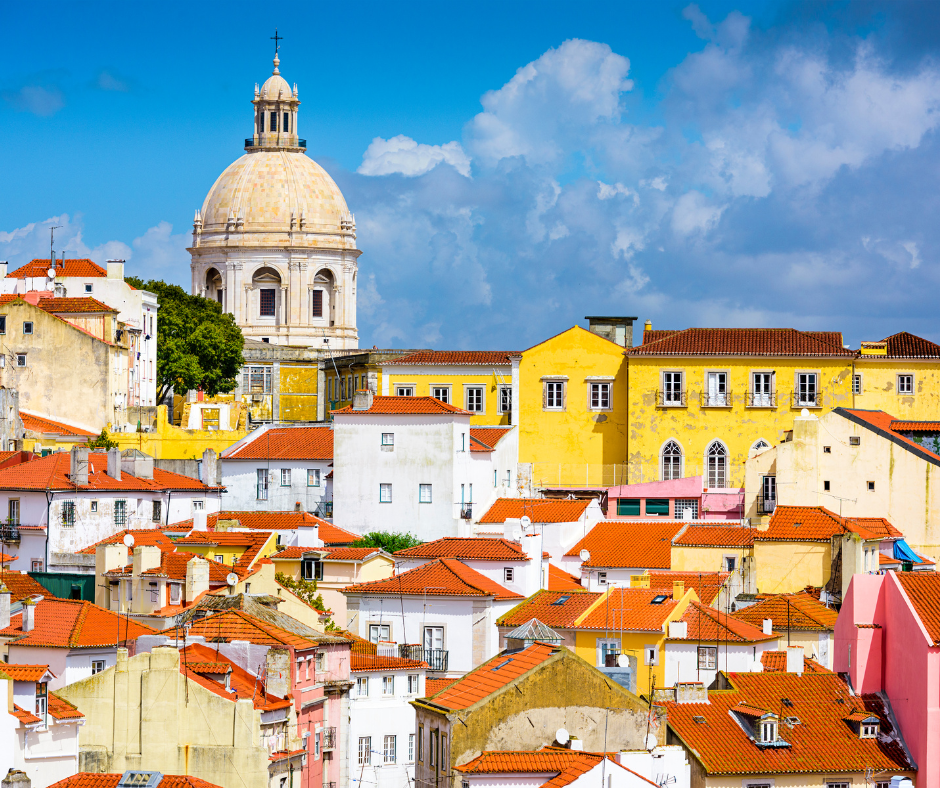 Skyline view of Lisbon, Portugal, featuring the colorful rooftops and historic buildings of the Alfama district—one of the top European destinations for 2025.