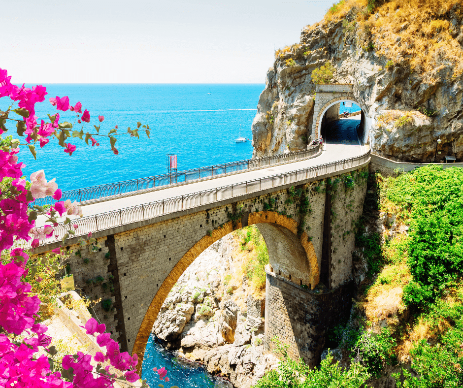 Driving along the scenic Amalfi Coast road in Italy overlooking the Mediterranean Sea