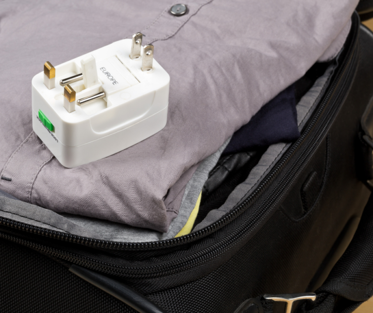 A travel power adapter featuring interchangeable connectors for European, UK, and US power plugs. This versatile adapter allows travelers to easily charge their devices in multiple regions, ensuring compatibility with different plug types and voltage standards.
