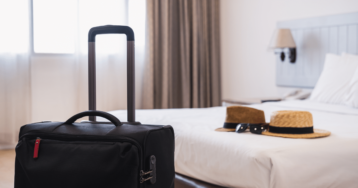Hotel room with luggage and summer hats, representing smart planning for a European vacation