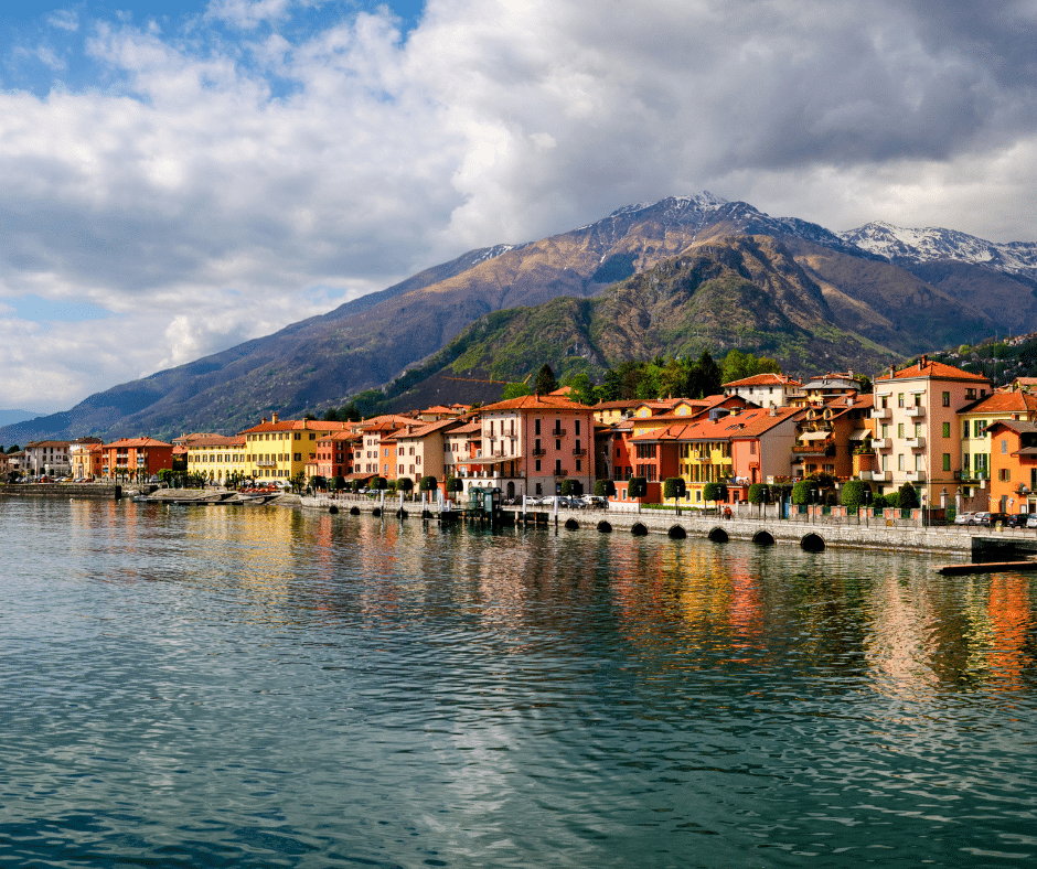 Colorful lakeside buildings in Varenna on Lake Como with mountains rising above the water in Italy