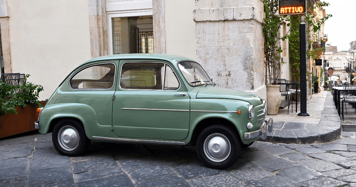 Small car parked on a narrow European street, reflecting the compact spaces that often surprise American travelers