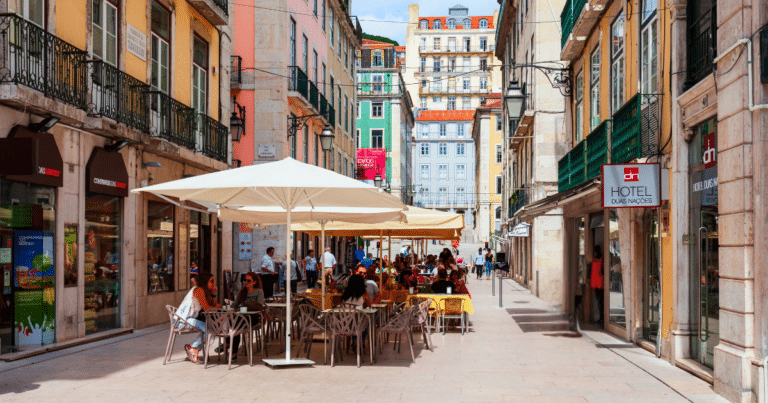 Outdoor café on a colorful European street, reflecting the cultural differences that surprise Americans traveling in Europe