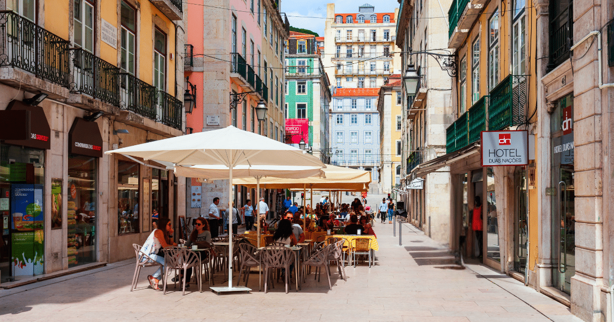 Outdoor café on a colorful European street, reflecting the cultural differences that surprise Americans traveling in Europe